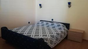 a bedroom with a bed with a black and white comforter at Apartment Stinica 26 E in Jablanac