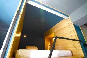 a bedroom with a bed and a window at DONGMEN 3 Hostel in Taipei