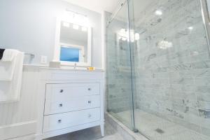 a bathroom with a sink and a glass shower at Town & Tide Inn in Newport