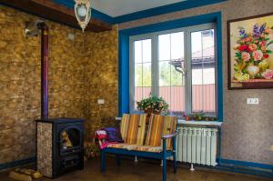 a room with a chair and a wood stove at Medovo House in Domodedovo