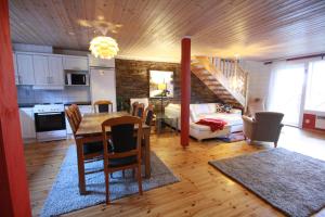 a kitchen and dining room with a table and a living room at Villa Falken in Åre