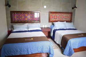 Postel nebo postele na pokoji v ubytování Hotel Las Candelas de Huamantla