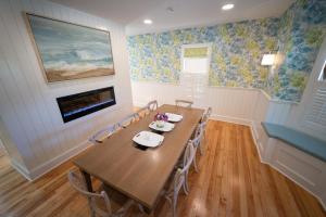 a dining room with a wooden table and chairs at Town & Tide Inn in Newport