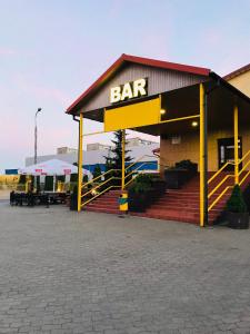 a restaurant with a bar sign on a building at Zajazd Fadom in Łomża