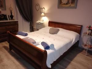 a bedroom with a bed with three pillows on it at Le Clos des Aramons in Bernis