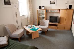 a living room with a table and chairs and a tv at Apartment Dresden Neustadt in Dresden