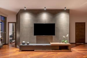 a living room with a flat screen tv on a wall at Luxury Panoramic Vilnius apartment in Vilnius