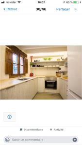 a kitchen with a sink and a stove top oven at Font Fresca House in Deia