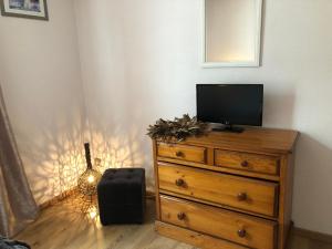 a bedroom with a dresser with a television on it at SARL l'Alzina in Vernet-les-Bains