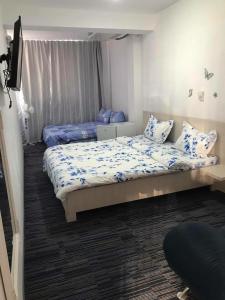 a bedroom with two beds and a flat screen tv at Casa Mario in Baile Felix