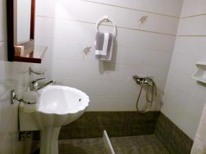 a bathroom with a sink and a shower at Madonna Studios in Chania Town