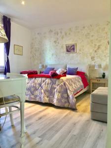 a bedroom with a bed and a table and a desk at Trieste Panoramico in Trieste
