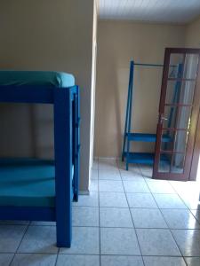 a room with two bunk beds and a mirror at Pousada Toca Do Raul in Itapoa +12 photos