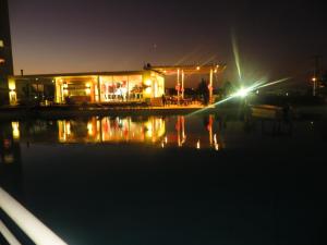 a restaurant at night with a reflection in the water at Condominio Laguna Vista Camino Casablanca 788 Algarrobo in Algarrobo