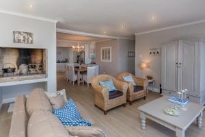 a living room with a couch and chairs and a table at Ons C-Huis - Gansbaai Seafront Accommodation, back-up power in Gansbaai