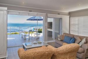 a living room with a couch and a view of the ocean at Ons C-Huis - Gansbaai Seafront Accommodation, back-up power in Gansbaai