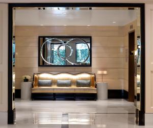 a gold couch in a lobby with a window at The London West Hollywood at Beverly Hills in Los Angeles