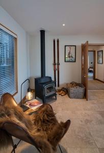 a living room with a wood stove in a room at Panorama House by Sotheby's Luxury Rental Homes in Queenstown +15 photos