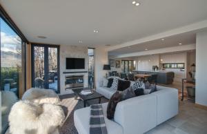 a living room with a couch and a fireplace at Panorama House by Sotheby's Luxury Rental Homes in Queenstown