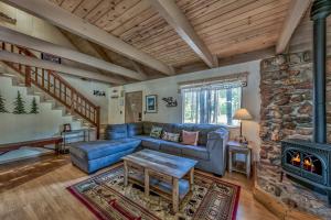 a living room with a blue couch and a fireplace at 1625A Atroari Chalet in South Lake Tahoe
