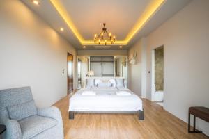 a bedroom with a white bed and a couch at Nakara Hill Phuket in Chalong  +44 photos