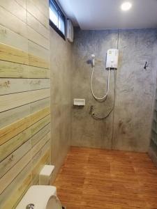 a bathroom with a shower and a toilet at Sands Place Apartment and Hotel in Samut Sakhon