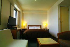 Vuode tai vuoteita majoituspaikassa Tourist Hotel Hitachi