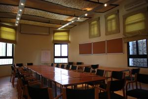 a large room with a long table and chairs at Azraq Lodge in Al Azraq ash Shamālī