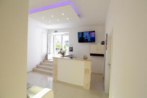 a white kitchen with a counter in a room at Villa Rajski Dvor 2 in Bol