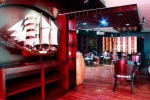a restaurant with a pirate ship on the wall at Kyriad Arra Hotel Cepu in Cepu