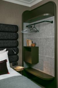 a bathroom with a large mirror and a bed at La Planque Hotel in Paris