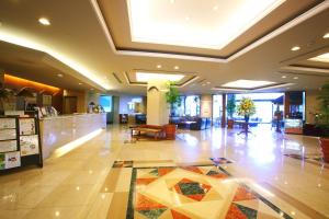 a lobby of a hotel with a tile floor at Sky Park Hotel in Chino