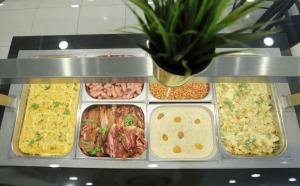 a display case with many different types of food at Aurora Hotel Klaipeda in Klaipėda
