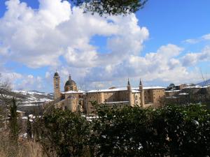 a large building with a clock tower on top of it at B&B Aquilone in Urbino