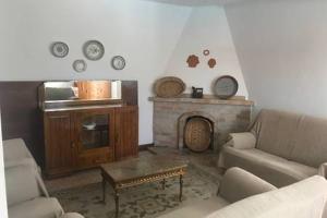 a living room with a couch and a fireplace at Casa da Avó Tita in Cardeal