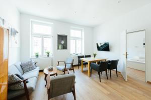 a living room with a couch and a table at The newPAST Apartments in Vienna