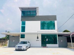 a car parked in a parking lot in front of a building at LunaStay (Shared Common Area) in Lunas
