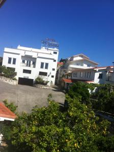 a large white building in front of some buildings at Hotel Casa Portuguesa in Loures