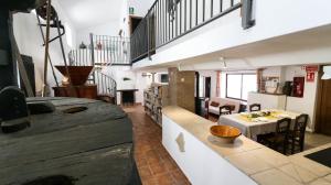 a living room with a table and a dining room at El Molino del Panadero in Jimera de Líbar