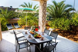 a table with fruit on it on a patio at Residence Valentina in Balestrate