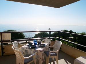 a table and chairs on a balcony with the ocean at Villa Matilde in Grado