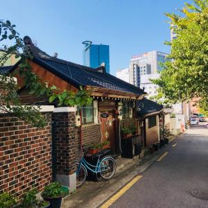 a bike parked outside of a brick building at ICOS Guesthouse 1 - Female Only in Seoul