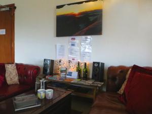 a living room with a couch and a table at Skye Basecamp Climbers' Bunkhouse, Isle of Skye in Broadford