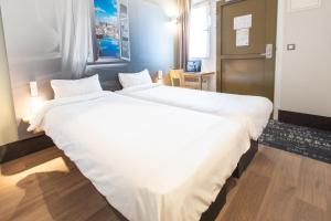 Ein Bett oder Betten in einem Zimmer der Unterkunft B&B HOTEL Saint-Malo Centre
