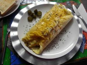 a white plate with a hot dog with cheese and olives at Art Guest House in Lutzville +21 photos