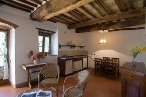 a kitchen and dining room with chairs and a table at Fattoria Casa Sola in Barberino di Val dʼElsa