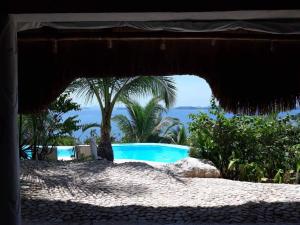 a view of a swimming pool from an umbrella at AL FARO Cosmio Hotel Palawan in Busuanga