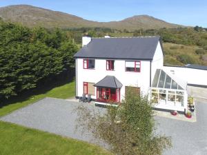 an aerial view of a white house with red windows at Poppyfield House, Kenmare in Kenmare