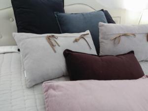 a pile of pillows sitting on a bed at Living-in-History: Heidi Braun Cottage in Dudeldorf