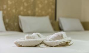 einen Haufen Handtücher auf einem Bett in der Unterkunft Coco's Guest House in Ko Phi Phi